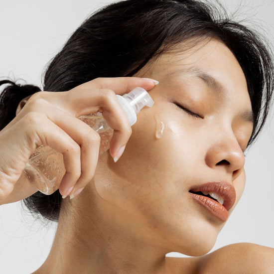 Woman applying hydrating face serum for glowing healthy skin