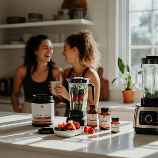 Two women making healthy protein smoothies with wellness supplements
